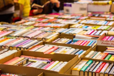 Used book sale with used books organized in boxes on tables
