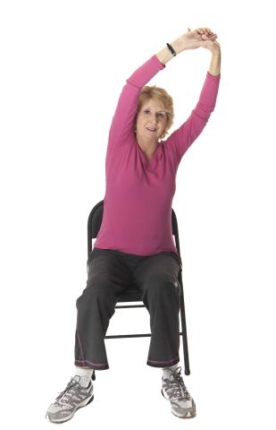 woman seated doing chair yoga